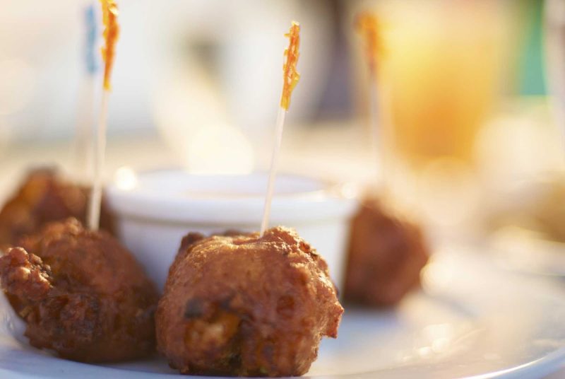 Try a local delicacy, conch fritters, while visiting Paradise Island in the Bahamas.