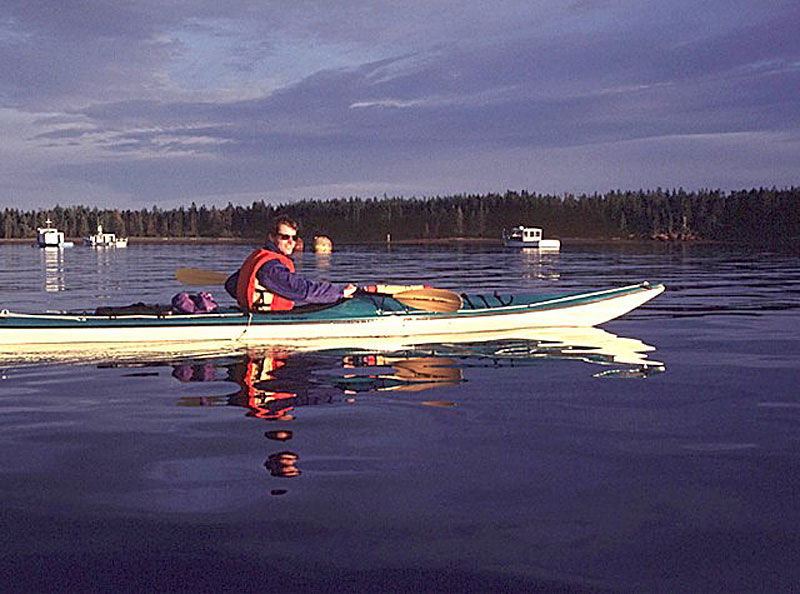 A kayaker explores the bay off St. Andrews-by-the-Sea in Atlantic Canada.