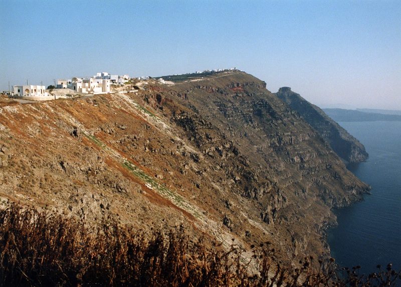 The caldera of Santorini with a view of the whitewashed houses of Fira perched atop sheer cliffs that plunge a thousand feet to the sea. An ocean-filled volcanic ring was left behind by a titanic eruption 3,500 years ago that devastated the region. It's one of the most stunning views in the world.