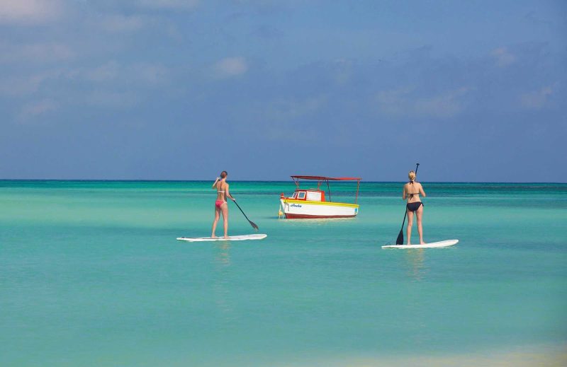 Two women on stand-up paddleboards in Aruba.