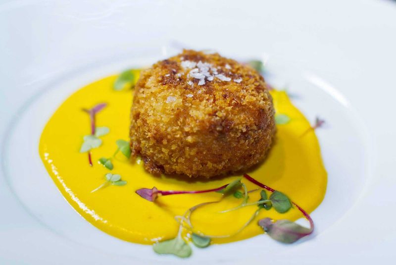 An appetizer with a rich, zesty sauce served at 150 Central Park aboard Allure of the Seas, under the direction of James Beard Award-winning chef and Miami restaurateur Michael Schwartz.