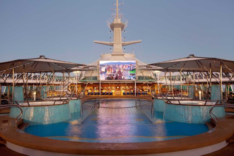 Watch a movie from the pool on Rhapsody of the Seas' outdoor movie screen.