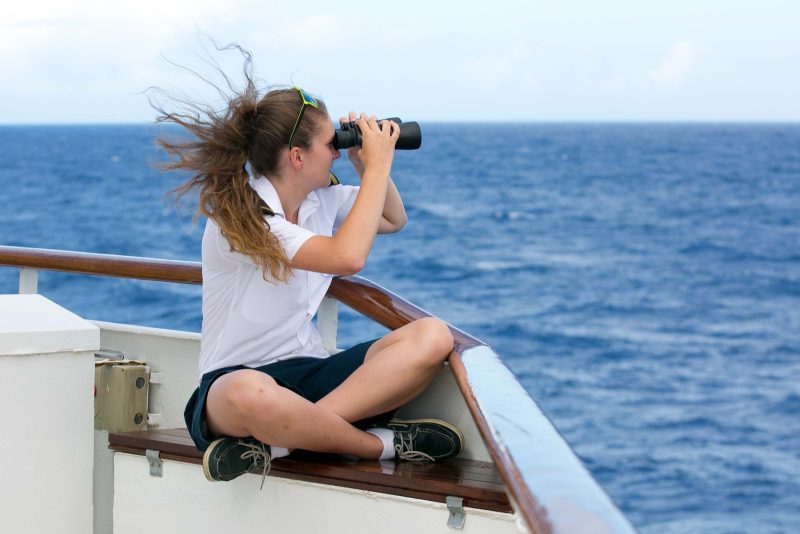 Deck cadet Lottie Astbury surveys the horizon from the bridge deck during a Wind Surf sailing.