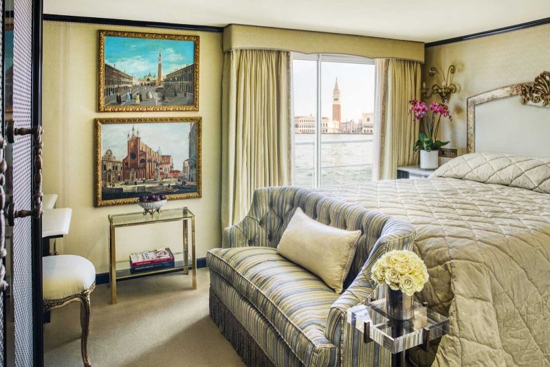 The bedroom of a luxurious suite aboard Uniworld’s S.S. La Venezia.