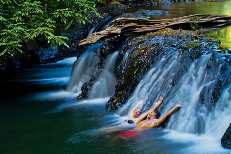 Go for a swim underneath one of Corcovado National Park's beautiful waterfalls on a Lindblad Expeditions tour.