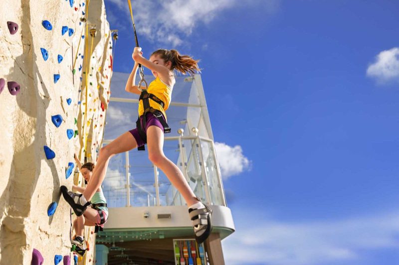 A young climber ascends to the top of Adrenaline Peak.