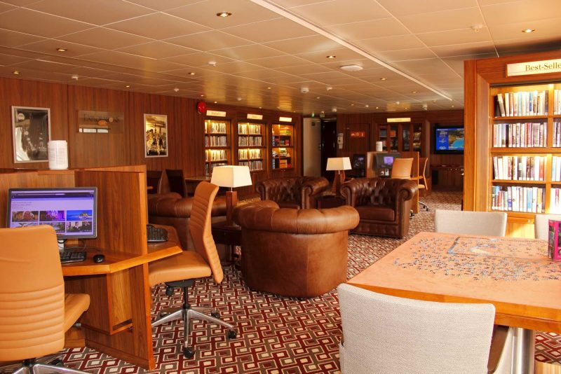 Find some solitude and a good read in the Explorations Café Library on ms Prinsendam.
