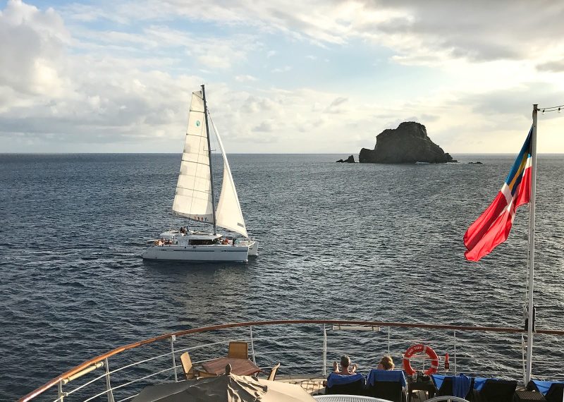 A catamaran at sunset in St. Barts seen from the deck of Wind Surf.