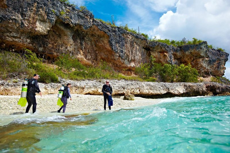 Scuba divers prepare to enter the tropical waters of Bonaire.