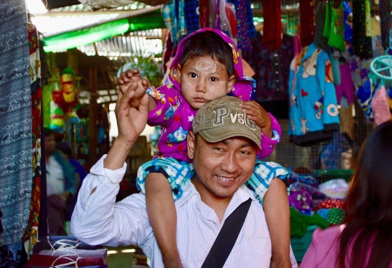 A father and son in a marketplace in the village of Myin Mu, Myanmar. 