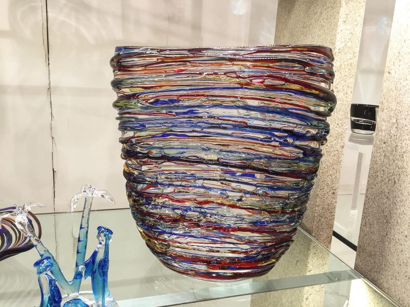 A colorful modern glass vase in a shop window along the Procuratie Vecchie on Piazza San Marco, Venice.
