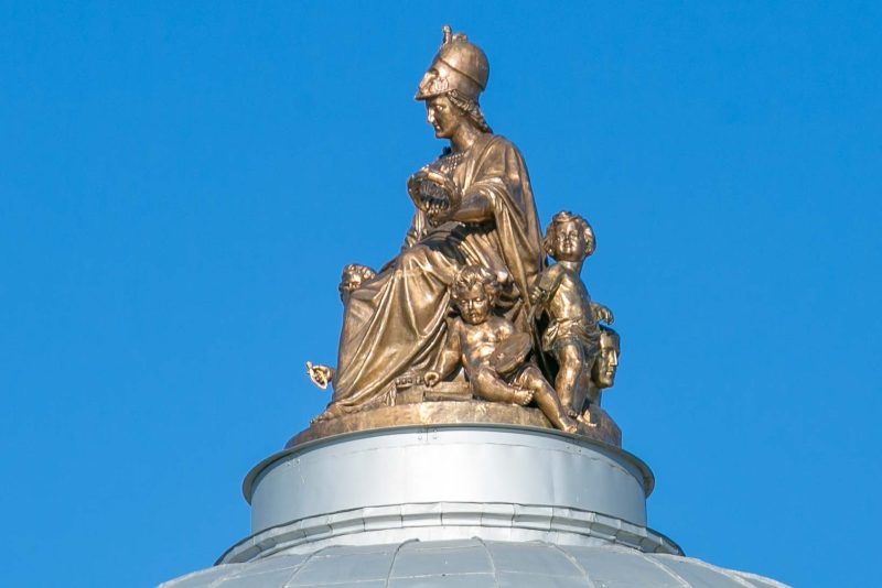 An ornamental statue topping a cupola along the banks of the Neva River  in St. Petersburg, Russia.