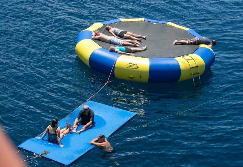 Passengers relax on a sunny afternoon on a giant ocean float at the rear of Wind Surf.