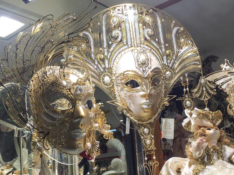 Gold masks in a shop window along the Procuratie Vecchie on Piazza San Marco, Venice.