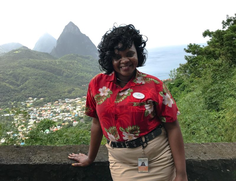 Verna, a tour guide in St. Lucia, poses in front of the Pitons.