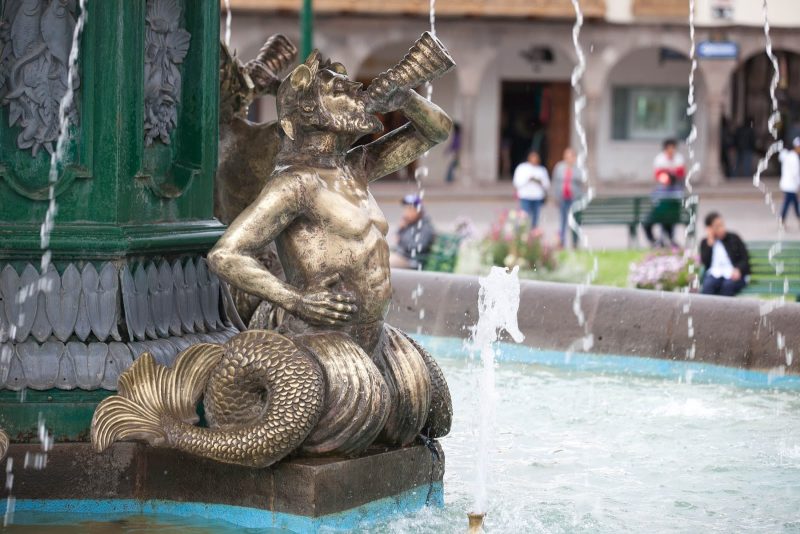 A figurine in the fountain at Plaza De Armas in Cusco, Peru.