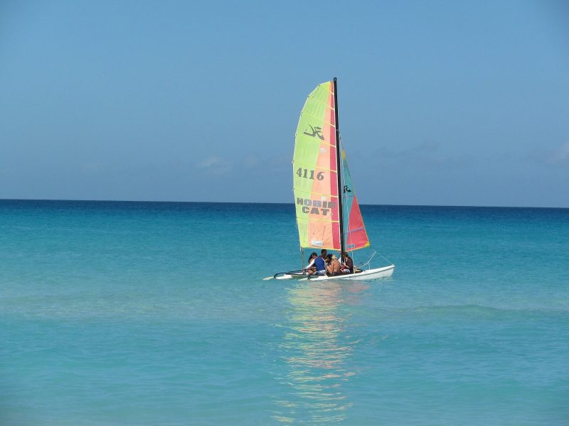 A HobieCat catamaran in the clear tropical waters of Cuba.