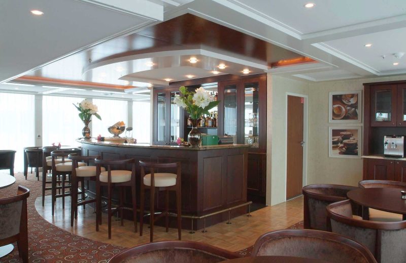 Guests can unwind after a day of sightseeing along the rivers of western Europe with a cocktail in the Panoramic Lounge Bar aboard AmaDagio.