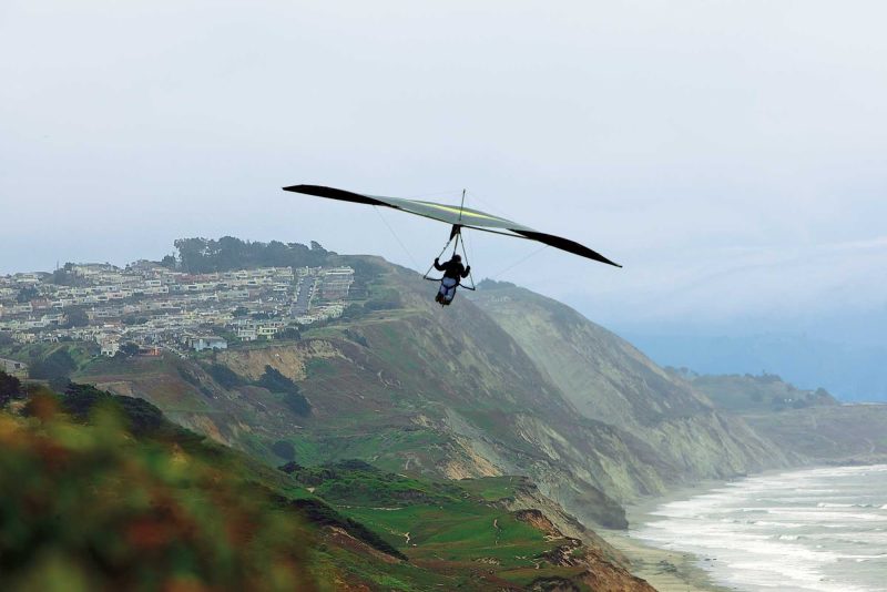 Hang gliding over the cliffs at scenic Fort Funston on the western edge of San Francisco. 