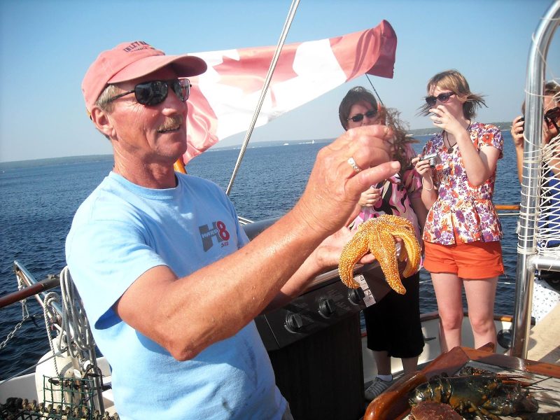 Showing off a starfish and other catches during a McNutts Island tour in Nova Scotia.