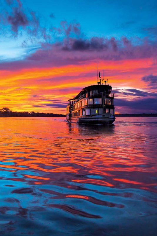 At sunset, Delfin II sails down the Marañon River, the principal source of the Amazon River.