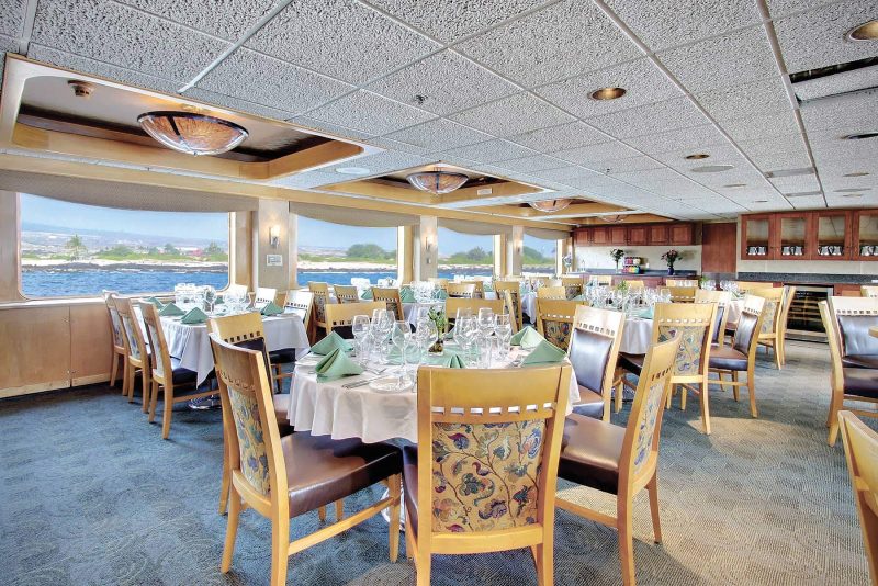 The light-filled main dining room aboard Safari Endeavour from Un-Cruise Adventures.