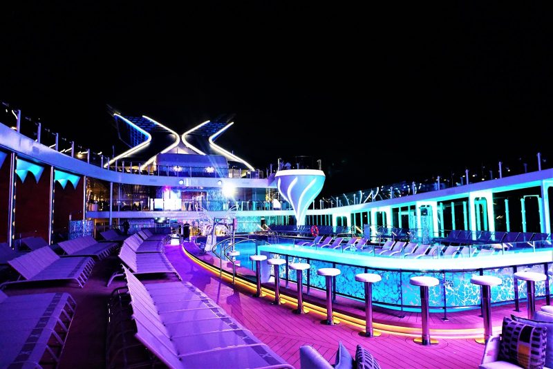 The Resort Deck on Celebrity Edge gets dolled up with rich neon colors at night.