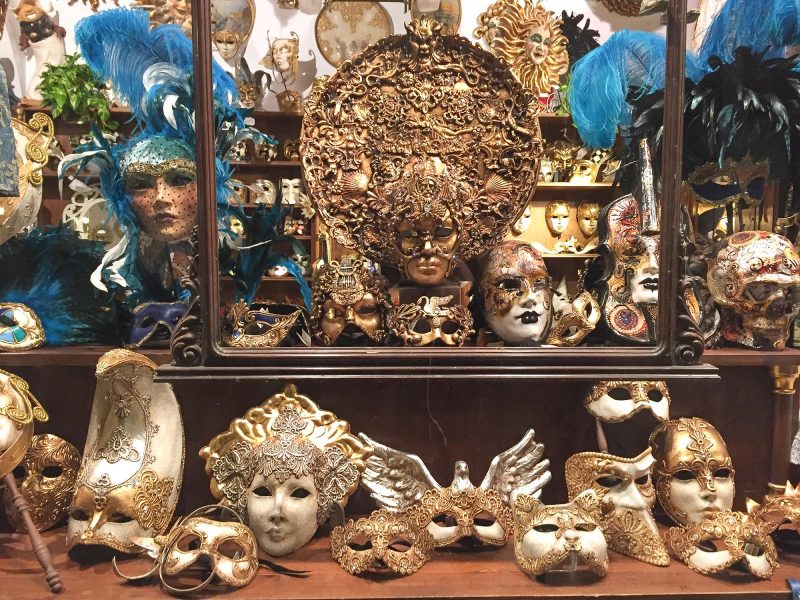 Masks and adornments in a Venice shop window.