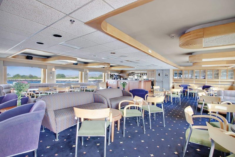 Mingle with new friends in the salon aboard Safari Endeavour from Un-Cruise Adventures.