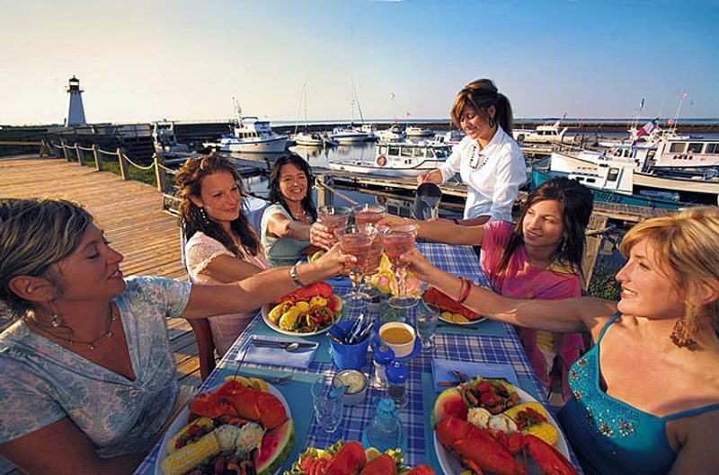 Women toast a sunny day and seafood feast in Shippagan, New Brunswick, Canada.