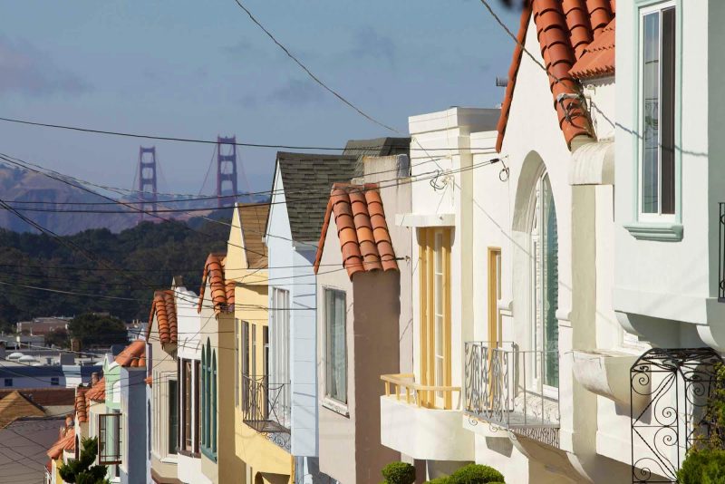 Rooftop view of San Francisco's Sunset district with the Golden Gate Bridge in the background.