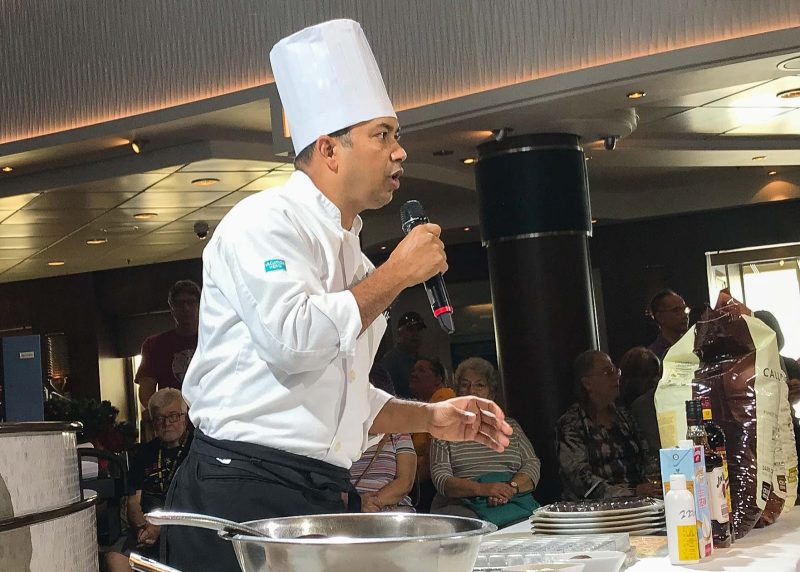 A chef instructs participants during a cooking demo on Norwegian Jade.