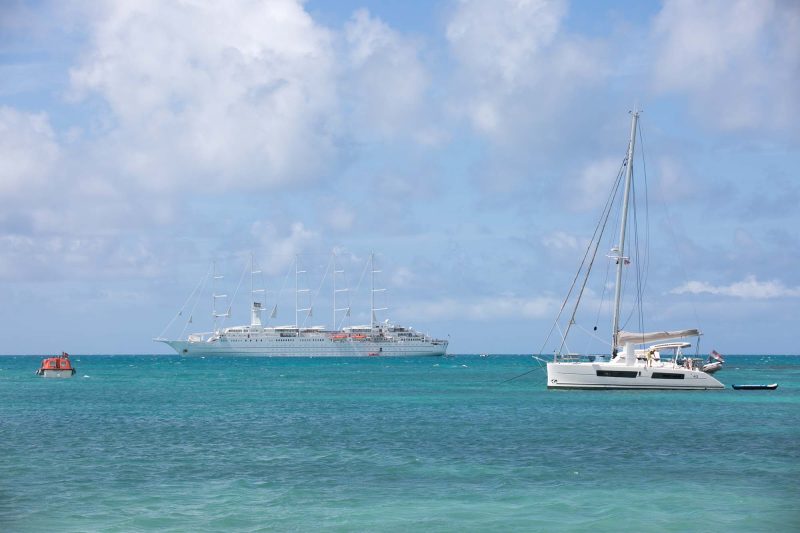 Wind Surf and smaller ships in an isolated cove in Barbuda in the Caribbean.