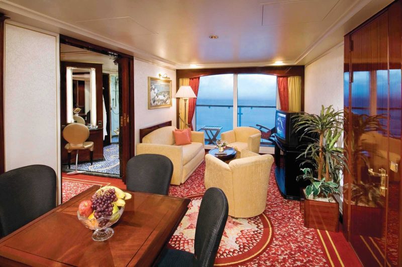 Comfortable bedroom furnishings and separate dining and living areas overlooking the  private balcony await you when you book a Penthouse with large balcony aboard Norwegian Spirit.