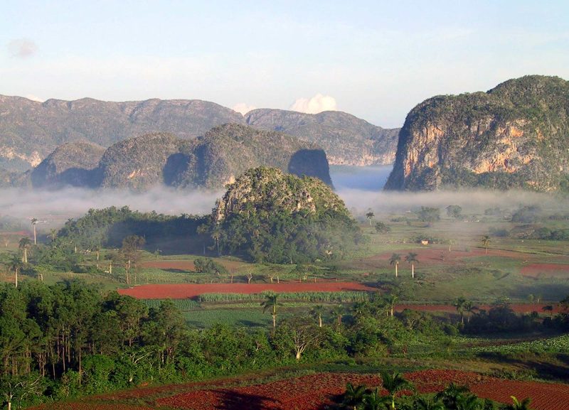 The morning fog lifts over a stretch of Cuba coastline.
