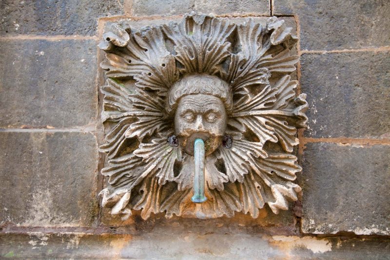 A sculpture affixed to a water fountain in Old Dubrovnik.