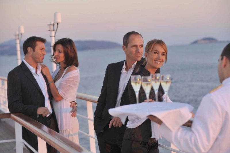 Sip fine Champagne on deck with fellow shipmates as you leave port on deck on your Ponant cruise.