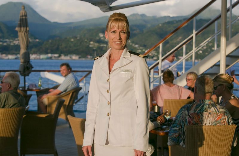  Amanda Millar, guest services director, at sunset on the aft deck of Wind Surf with St. Barts in the background.