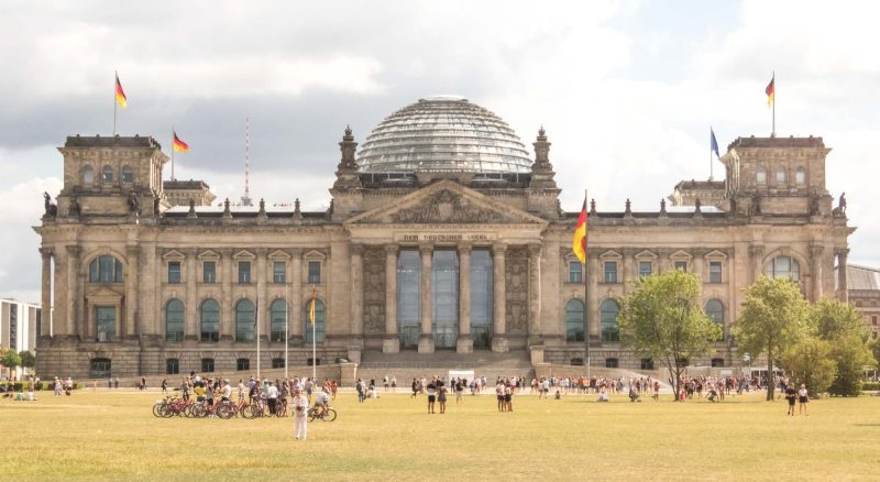 The west portal of the Reichstag building in Berlin. The inscription across the entrance says, “The German people.”