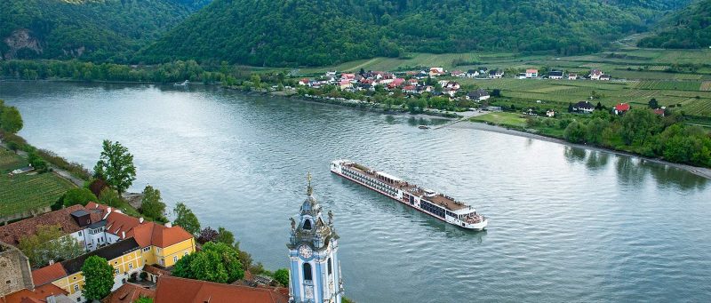 Aerial view of a Viking Njord sailing past Dürnstein, Austria, along the Danube River.