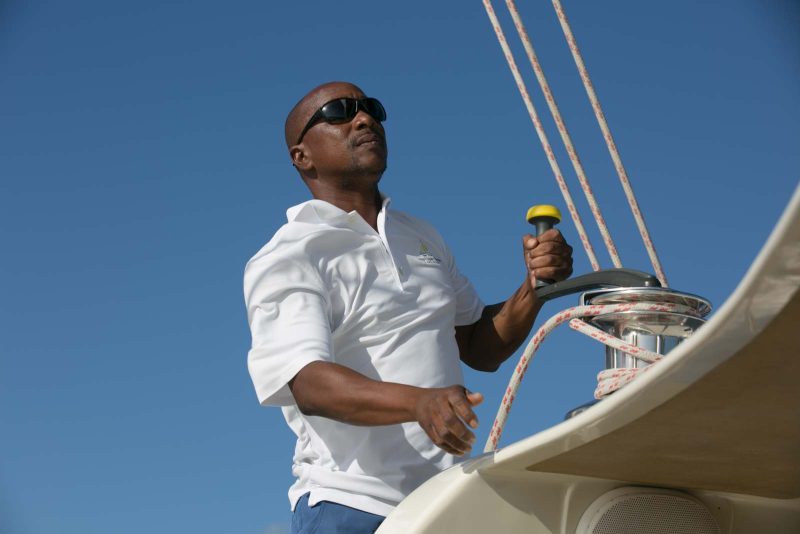 A crew member lowers the mast during a tour aboard the Spirit of St Kitts.