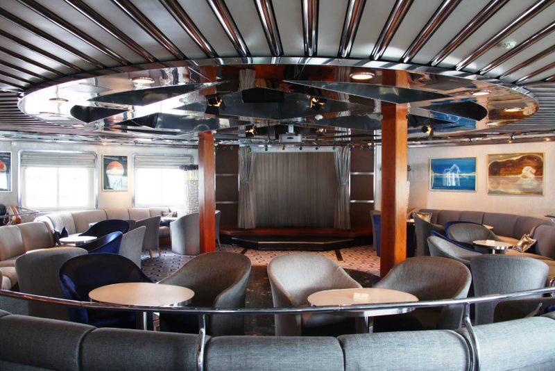 Relax back in the Grand Salon aboard a SeaDream Yacht Club cruise.