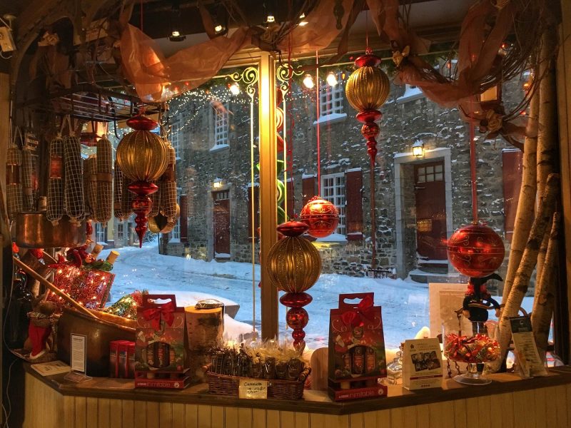 Christmas ornaments adorn the window of a charming old-timey store window in Quebec City, Canada.