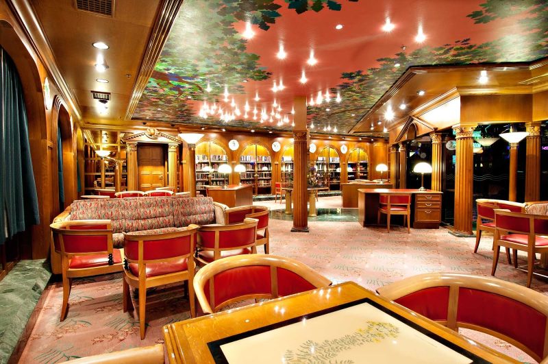 Spend some quiet time with a good book at Carnival Sensation's Oak Room Library.