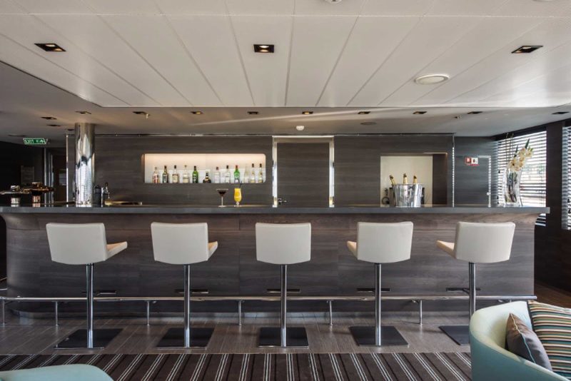 Order a drink and meet interesting new people in the bar on the Ponant luxury ship Le Soleal.