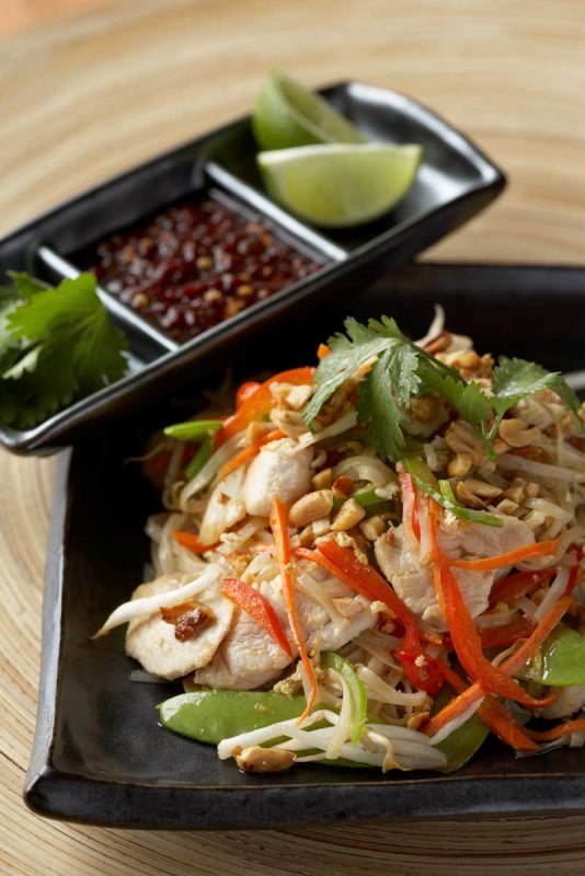 Pad Thai accompanied by a garnish of lime, coriander and chilli served in the Celebrity Cruises restaurant Silk Harvest.