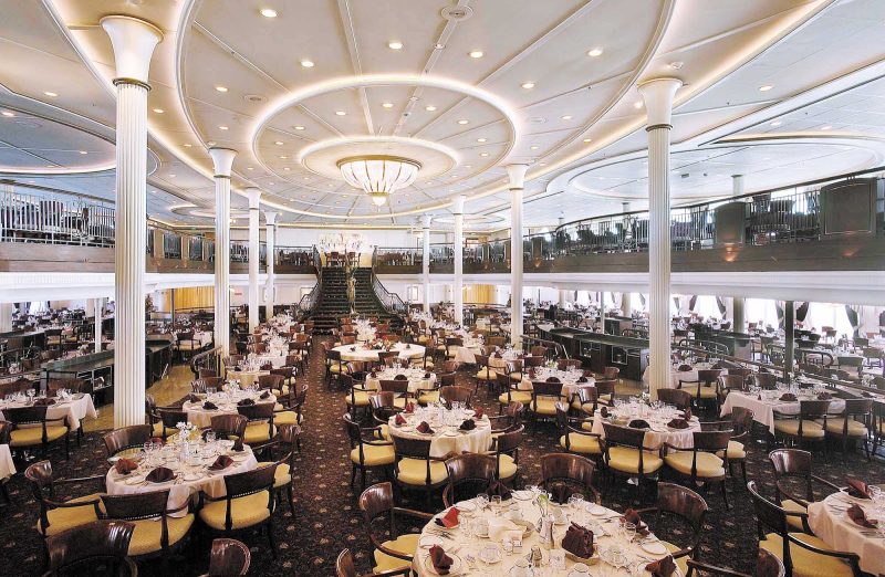 Dine at the My Fair Lady dining room on decks 4 and 5 of Enchantment of the Seas, which a grand staircase and waterfall that that recall scenes in the movie.