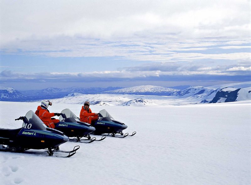 Take in the views during a snowmobiling tour during a day trip in Iceland.