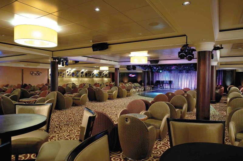 Dance the night away at the Spinnaker Lounge, one of the cozy yet festive spots aboard  Norwegian Dawn.