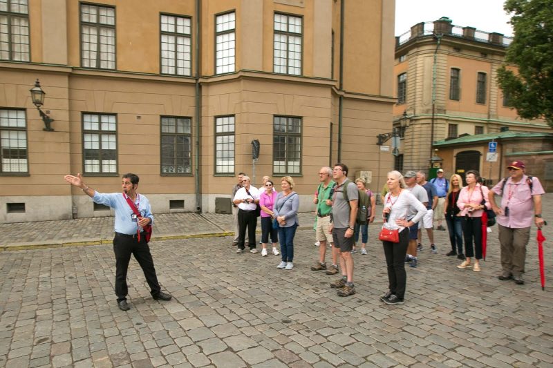 Gabriel Hultfred, a Viking tour guide, points to a landmark in Old Stockholm.